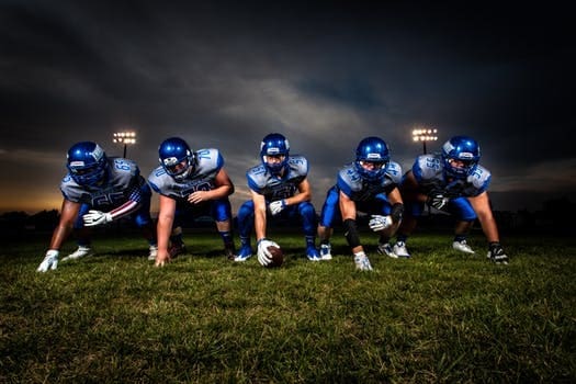 High school football team in starting line formation